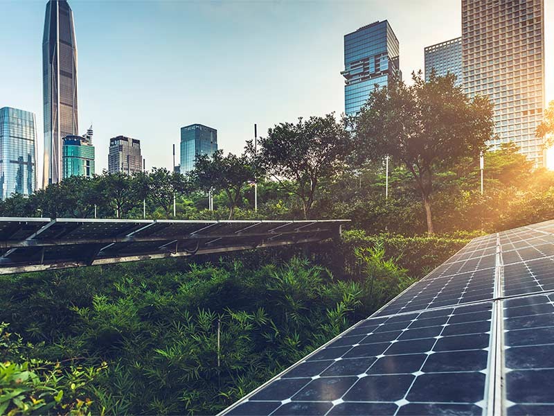 Solar panels and green space in city 